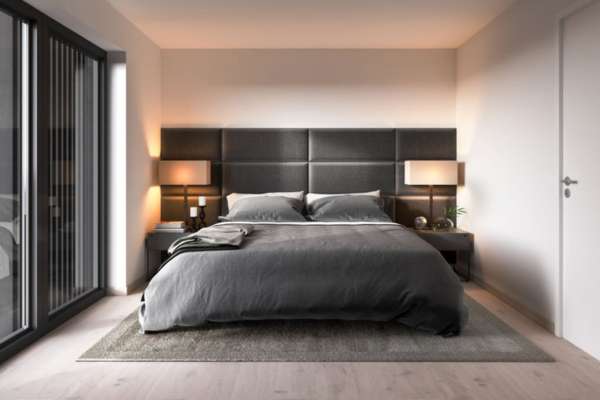 A Black Nightstand With Colorful Pillows